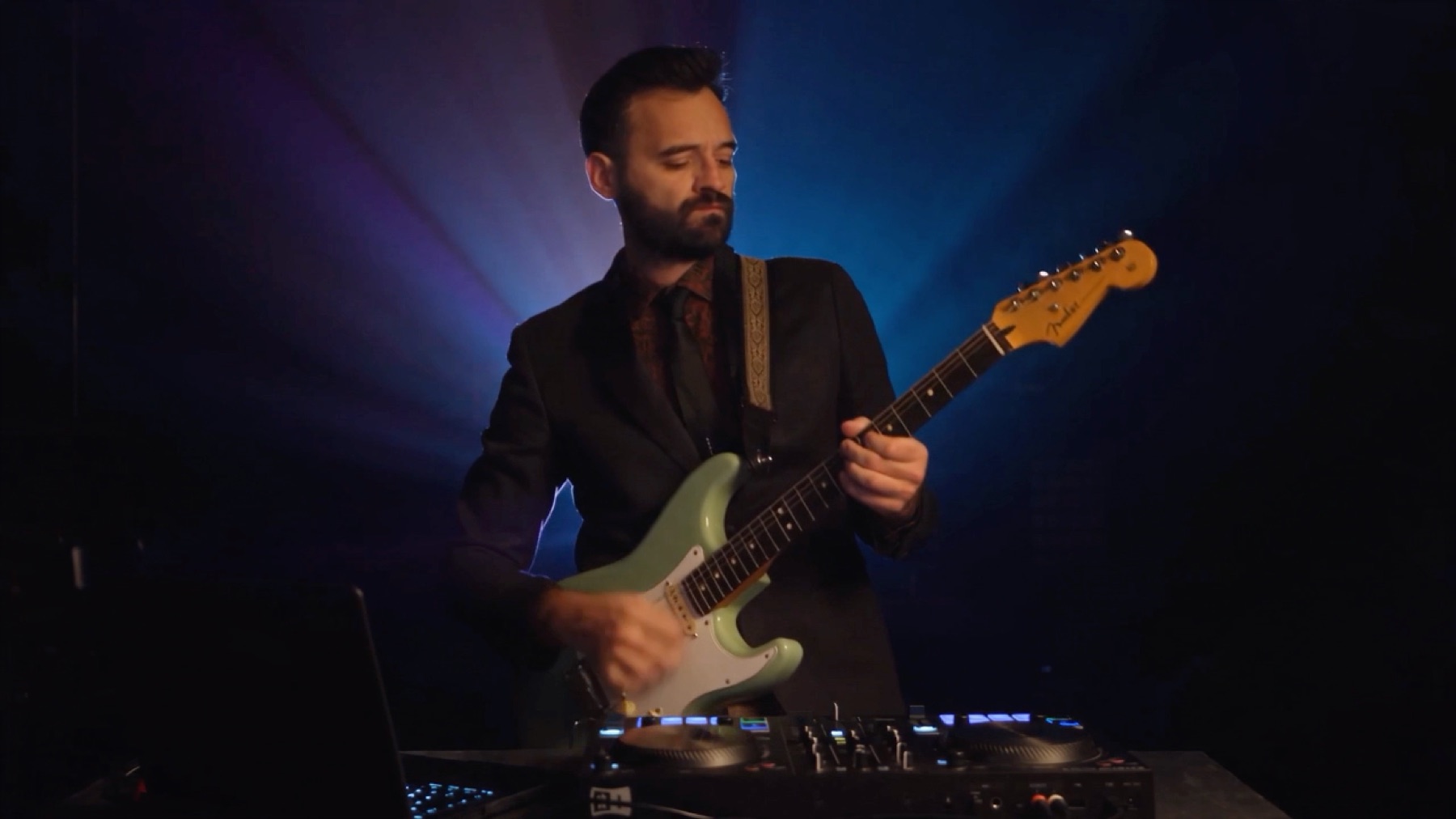 PARPAYON à la guitare électrique derrière ses platines DJ